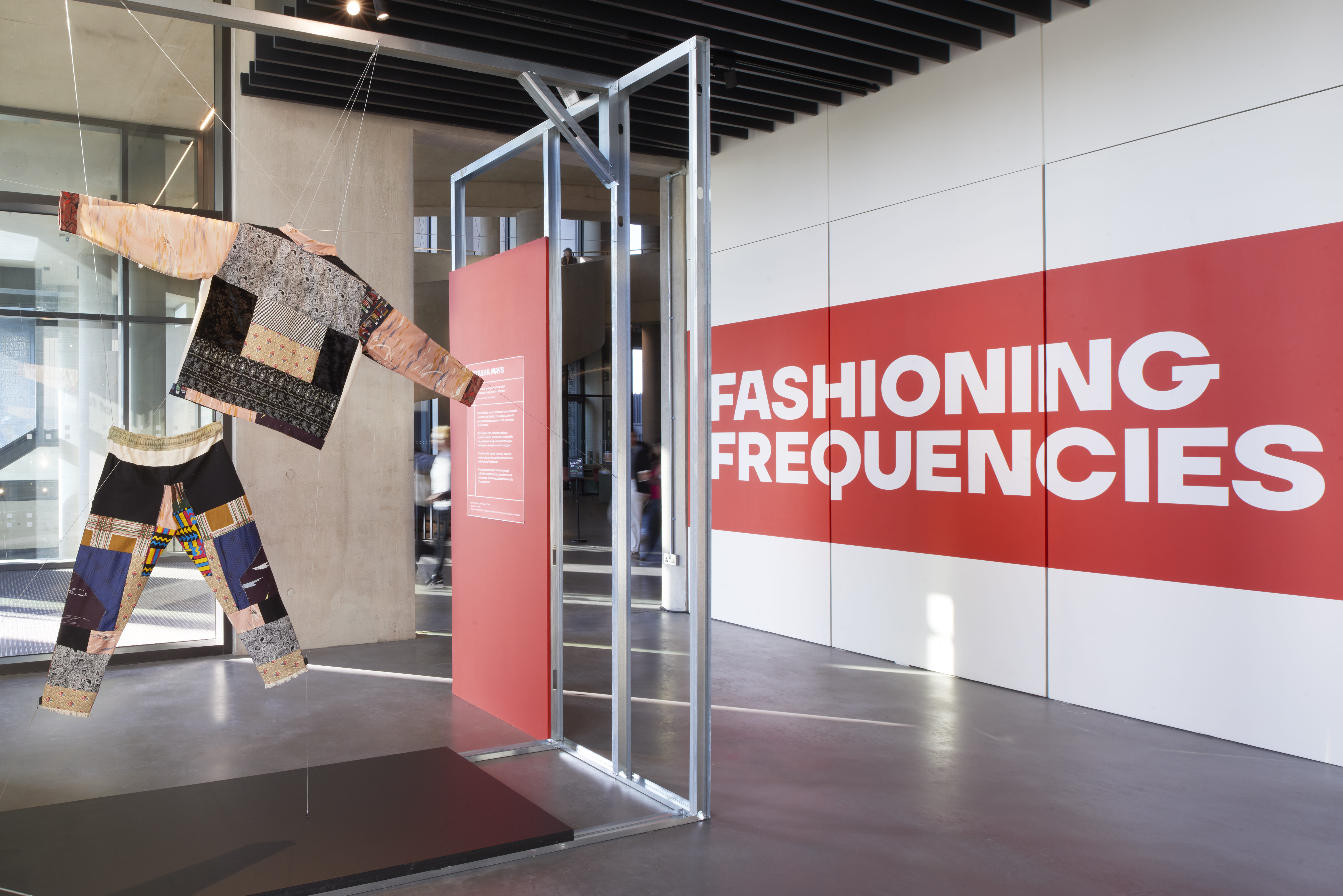 Fashioning Frequencies logo and outfit hanging by the window.